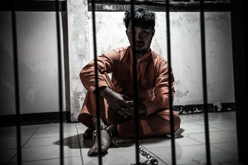 Asian man desperate at the iron prison,prisoner concept,thailand people,Hope to be free,Serious prisoners imprisoned in the prison