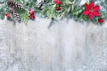 Wall Mural - christmas and new year background with fir branches and snowfall on wooden white board