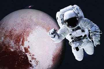 Wall Mural - astronaut near planet pluto of solar system in space with far galaxy on the background. science fict