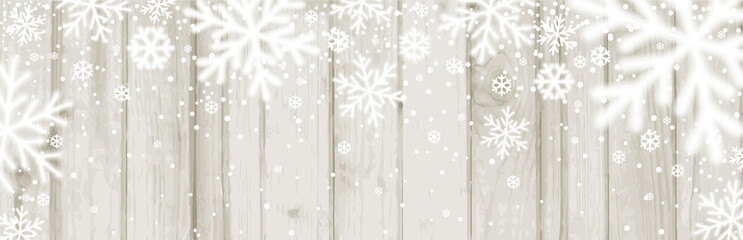 Wall Mural - christmas banner with white blurred snowflakes on wooden background. merry christmas and happy new y