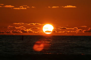 Sticker - the sun setting over the ocean