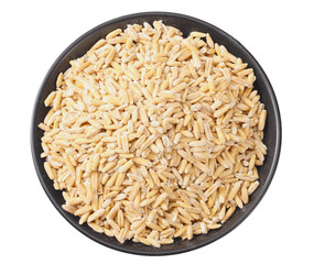 Wall Mural - wheat grains in a black plate isolated on white background. top view