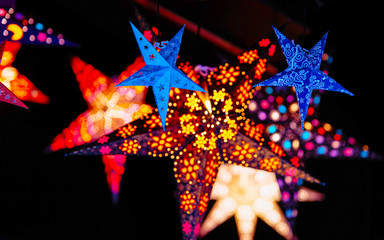 Wall Mural - Paper star light decoration at Christmas Market in Winter Berlin, Germany. Advent Fair and Stalls with Crafts Items on the Bazaar. In Europe. German street Xmas and holiday in European city or town.