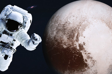Wall Mural - astronaut near planet pluto of solar system in space with far galaxy on the background. science fict