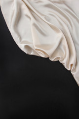 Wall Mural - beautiful white silk fabric draped in flowing folds with a black blank form, concept of tourism, emigration, economy and politics, close up