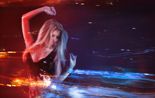 Young Blonde Woman Dancing At Night Disco Club. Motion Blur