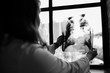 © DmitryStock - The doctor holds in his hands a picture of his patient’s lungs and looks at the lumen opposite the window.