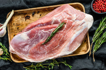 fresh pork cuts. Raw meat with spices.   shoulder butt part.. Black background. Top view