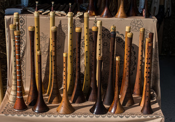 Dozens of handmade wooden flutes in display