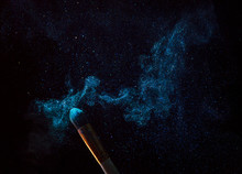 Make-up Brush With Blue Powder Explosion Isolated On Black Background