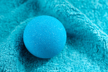 Blue bath bomb on towel background