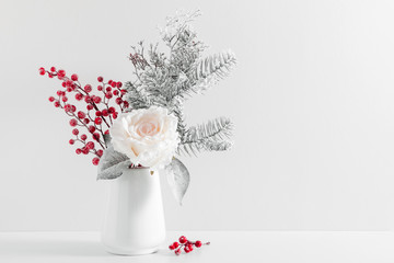 Winter composition, decoration, flowers, branches in vase on white background. Christmas, New Year, winter concept. Front view, copy space