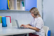 © romankosolapov - Portrait of medical expert at work, looking at laptop, working