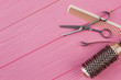 © DenisProduction.com - Hairdresser combs and scissors on pink background. Tools for hair cutting. Space for text.