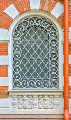 Canvas Print - Close-up of ancient vintage arch window with cast iron white lattice, pattern