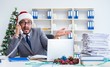 © Elnur - Young businessman celebrating christmas in the office