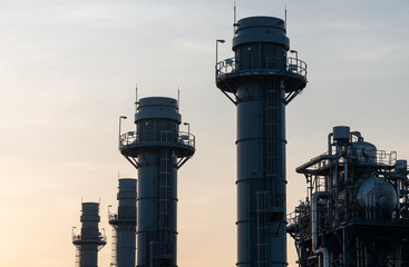 silhouette of oil refinery at twilight