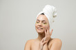 © Mountains Hunter - Young beautiful girl in a white towel on his head wears collagen gel patches under her eyes. Mask under eyes treatment face.