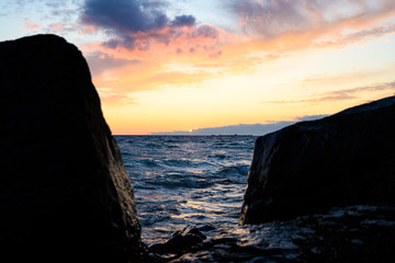 sunset framed between two large rocks