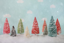Miniature Bottle Brush Christmas Trees On A Snowy Background