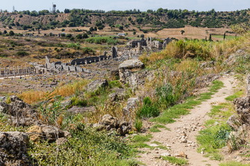 Wall Mural - The road from hill near Perga or Perge, an ancient Greek city in Anatolia, a large site of ancient ruins, now in Antalya Province on the Mediterranean coast of Turkey.