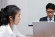 © tuaindeed - frustrated stressed Asian business female suffering from severe depression during meeting.