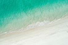 Aerial Drone View Of Sandy White Beach In Summer With Brilliant Blue Turquoise Waters