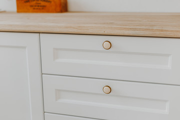 Wall Mural - Closed light-colored kitchen drawer with plates inside, a smart solution for storing and organizing the kitchen.