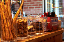 Variety Of Cookies In Glass Jars On Counter At Coffee Shop