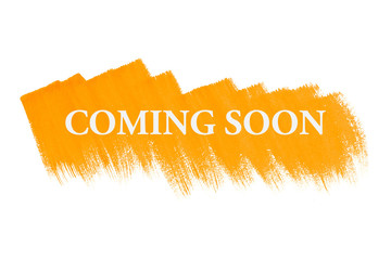 Coming soon on yellow paint background, isolated on white. Advertising banner concept.