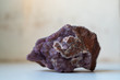natural spessartine stone of violet color on a light background