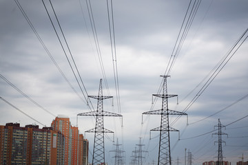 power transmission line in the city with cloudy sky