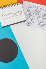 Poster - top view of notebook with prototyping lettering and website design template on abstract geometric background