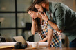 © JustLife - Colleagues in office. Businesswoman and businessman discussing work in office. Two friends in working together.