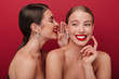 © Drobot Dean - Cheery positive two women with bright red lipstick