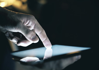 Wall Mural - Businessman hand touching tablet.