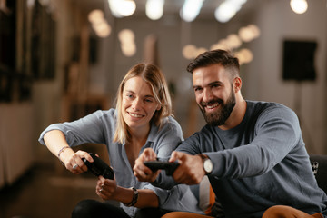 Wall Mural - Happy young couple. Couple playing video game. 