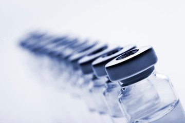 Glass medicine vials on a white background