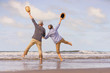 © pic for you - Asian senior couple jumping on the beach.elderly honeymoon together very happiness after retirement.plan life insurance.Activity after retirement on summertime