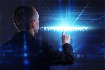 Business, Technology, Internet and network concept. Young businessman working on a virtual screen of the future and sees the inscription: Cryptocurrency