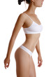 © nazarovsergey - Perfect, slim, toned, young body of a girl in white underwear posing isolated on white. Plastic surgery and aesthetic cosmetology concept. Close-up.