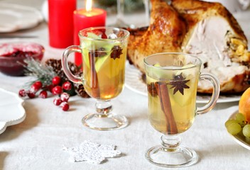 Sticker - christmas hot cider. hot winter drink Cranberry Apple Cider Punch. Garnish with apples, oranges, and cranberries. hot apple cider with spices on a festive table on Christmas or New Year.