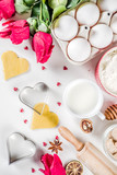 Fototapeta Mapy - Valentine day baking background. Ingredients for cooking Valentine's heart cookies. Flour, eggs, sugar, spices on wooden background with red flower roses. Top view copy space.