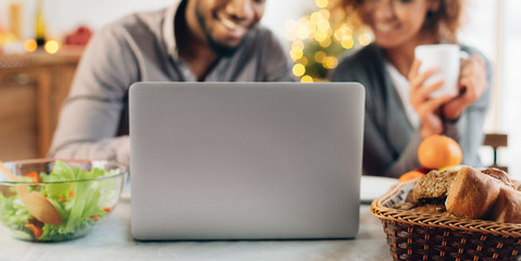 Young man and woman using laptop computer