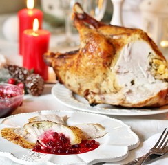 Canvas Print - Christmas turkey with cranberry sauce on the holiday table and candles