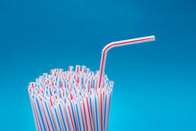 Plastic Straws On A Blue Background. Space For Text