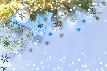 boxes with gifts and Christmas accessories: snowflakes, toys, bells, spruce branches. Christmas background with presents, snowflakes, and toys.