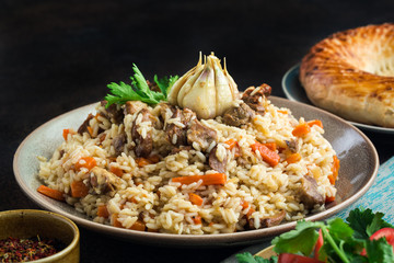 Canvas Print - Uzbekistan  national dish - plov, made from: uzbek Devzira rice, lamb, onion, carrot, spiced with cumin, coriander, barberries, red pepper, prepared with head of garlic.