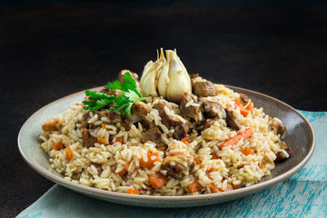 Wall Mural - Uzbekistan  national dish - plov, made from: uzbek Devzira rice, lamb, onion, carrot, spiced with cumin, coriander, barberries, red pepper, prepared with head of garlic.