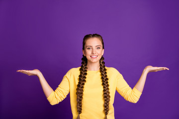 Canvas Print - Photo of amazing manager lady long braids advising cool shopping prices holding two novelty products on open arms wear casual yellow pullover isolated purple color background